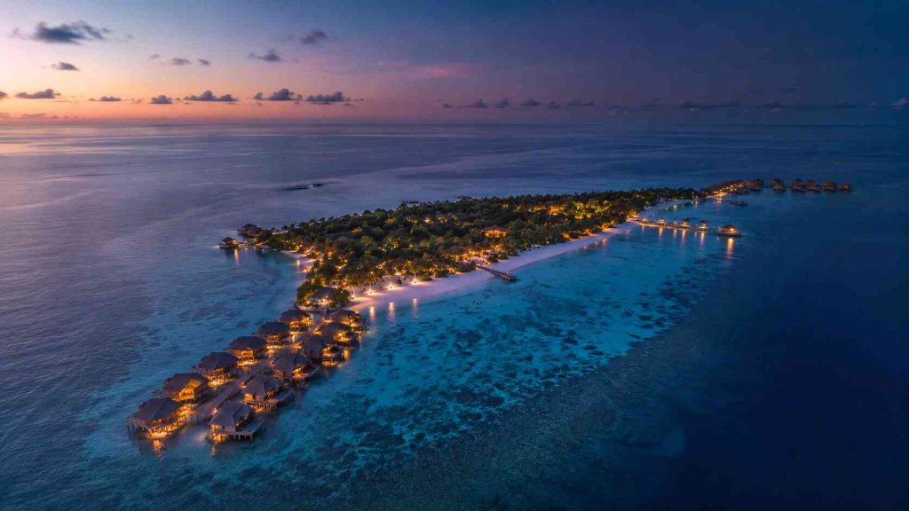 Aerial overview of Gili Lankanfushi private island Kashiveli with Crusoe Residence overwater villas at dawn North Male Atoll Maldives
