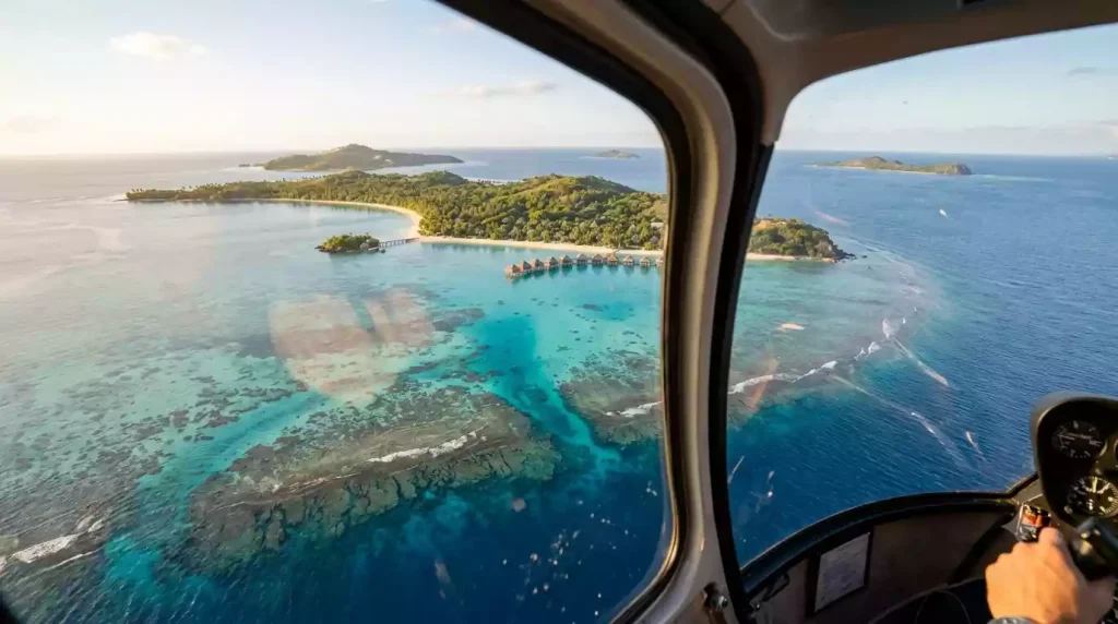 Helicopter aerial view over Mamanuca Islands coral reef approaching Likuliku Lagoon Resort Malolo Island Fiji
