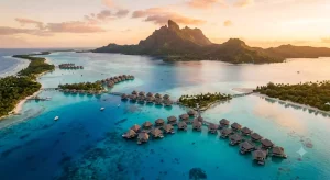 Aerial view of Bora Bora's turquoise lagoon with overwater bungalows and Mount Otemanu