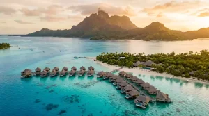 Aerial view of overwater bungalows with Mount Otemanu in the background at Four Seasons Bora Bora