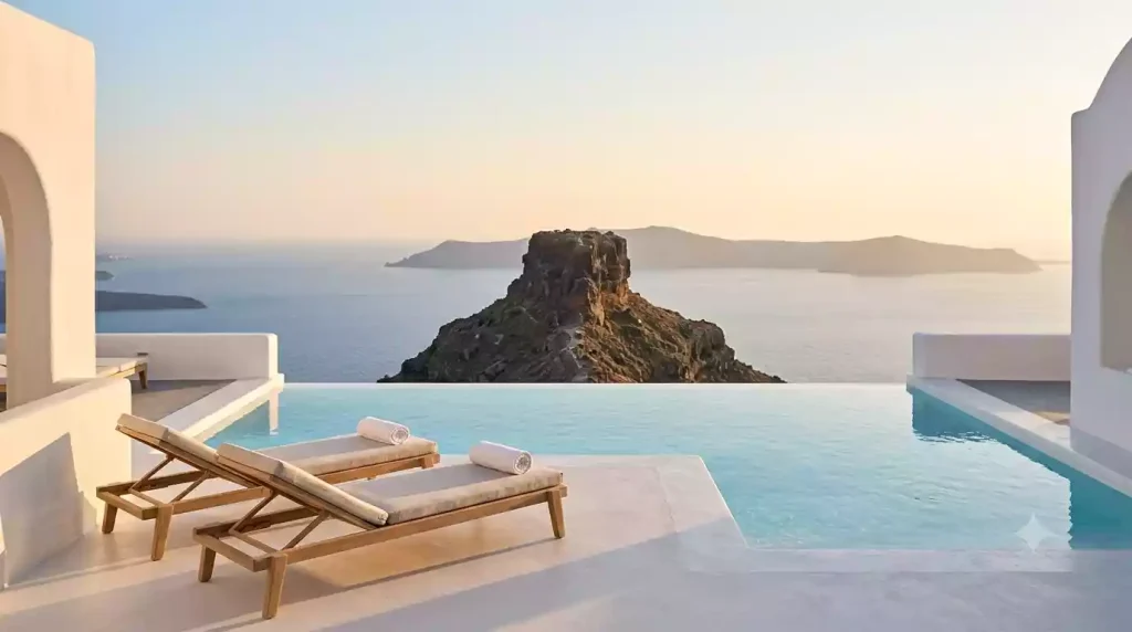 Grace Hotel Santorini's signature infinity pool at sunrise