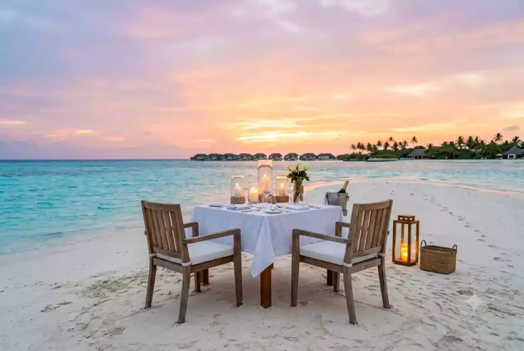 Private sandbank dinner setup in the Maldives at sunset